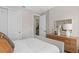 Bedroom featuring a light wood dresser, neutral decor, and a view to another room at 6920 Dappled Oak Way, Orlando, FL 32829