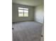 Cozy bedroom with plush carpeting and a view overlooking the exterior landscape at 6920 Dappled Oak Way, Orlando, FL 32829