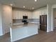 Modern kitchen with stainless steel appliances, granite countertops, and a central island at 6920 Dappled Oak Way, Orlando, FL 32829
