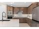 Well-equipped kitchen featuring custom cabinetry, stainless steel appliances, and stylish backsplash at 6920 Dappled Oak Way, Orlando, FL 32829