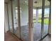 View of covered lanai featuring stone flooring with a lake view in the background at 6920 Dappled Oak Way, Orlando, FL 32829