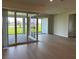 Spacious living room area featuring large sliding doors to the covered lanai at 6920 Dappled Oak Way, Orlando, FL 32829