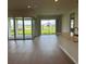 Bright open-concept living area with hard floors and sliding glass doors to a screened porch at 6920 Dappled Oak Way, Orlando, FL 32829