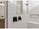 Modern walk-in shower featuring white subway tile, dark hardware, and built-in bench at 6920 Dappled Oak Way, Orlando, FL 32829