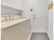 Bright laundry room featuring washer, dryer, storage cabinets and access to outdoors at 843 Julliard Ct, Orlando, FL 32828