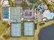 An aerial view of tennis and basketball courts, along with a parking lot and the community pool and playground at 843 Julliard Ct, Orlando, FL 32828