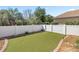 Backyard with artificial grass, privacy fence, and tasteful stone landscaping at 8712 Sw 83Rd Cir, Ocala, FL 34481