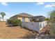 Fenced backyard with manicured rock landscaping, healthy shrubs, and a screened in patio at 8712 Sw 83Rd Cir, Ocala, FL 34481