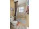 Bathroom features a shower and tub combination with glass doors, perfect for a refreshing and accessible bathing experience at 8712 Sw 83Rd Cir, Ocala, FL 34481