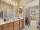 Bathroom with double vanity and sink and walk-in access to the main bedroom and a separate office at 8712 Sw 83Rd Cir, Ocala, FL 34481