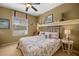 Comfortable bedroom with a ceiling fan, natural light, and coastal-themed decor, creating a relaxing atmosphere at 8712 Sw 83Rd Cir, Ocala, FL 34481