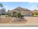 Charming single-story home with a manicured front yard and brick-paved driveway and neutral tan exterior at 8712 Sw 83Rd Cir, Ocala, FL 34481