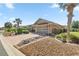 Attractive single-story home featuring a paver driveway, xeriscaping, and a two-car garage at 8712 Sw 83Rd Cir, Ocala, FL 34481