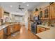 Bright kitchen with stainless steel appliances, natural wood cabinets, and hardwood floors, perfect for cooking and entertaining at 8712 Sw 83Rd Cir, Ocala, FL 34481
