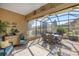 Covered lanai with comfortable seating, stylish decor, and scenic backyard views at 8712 Sw 83Rd Cir, Ocala, FL 34481