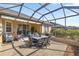 Screened lanai with a ceiling fan and patio furniture, perfect for outdoor entertaining at 8712 Sw 83Rd Cir, Ocala, FL 34481