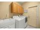 Functional laundry room with cabinets, utility sink, and modern washer and dryer at 8712 Sw 83Rd Cir, Ocala, FL 34481
