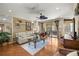 Cozy living room featuring hardwood floors, comfortable seating, and natural light and views to the lanai at 8712 Sw 83Rd Cir, Ocala, FL 34481
