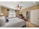 Inviting main bedroom with a ceiling fan, natural light, and ensuite bathroom at 8712 Sw 83Rd Cir, Ocala, FL 34481