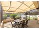 Outdoor patio space with dining table is screened-in with view of greenery for outdoor relaxation and entertaining at 8712 Sw 83Rd Cir, Ocala, FL 34481