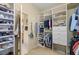 Well-organized walk-in closet featuring built-in shelving, drawers, and storage solutions for shoes and other items at 8712 Sw 83Rd Cir, Ocala, FL 34481
