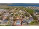 Aerial shot of the property highlighting its private backyard, in-ground pool, and neighborhood location near a lake at 100 Diamond Ridge Blvd, Auburndale, FL 33823