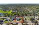 Aerial view of the home, showcasing its location in a quiet neighborhood with mature trees and well-maintained landscaping at 100 Diamond Ridge Blvd, Auburndale, FL 33823