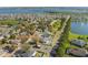 Expansive aerial view showcasing the neighborhood's picturesque streets and inviting homes near a lake at 100 Diamond Ridge Blvd, Auburndale, FL 33823