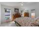 Well-lit bedroom featuring a view of the pool, comfortable bedding, and classic furnishings at 100 Diamond Ridge Blvd, Auburndale, FL 33823