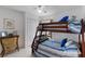 Bright bedroom with wooden bunk beds, white walls and a ceiling fan for comfortable living at 100 Diamond Ridge Blvd, Auburndale, FL 33823