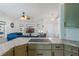 Modern kitchen with granite counters, stainless steel stove top, overlooking a living area with natural light at 100 Diamond Ridge Blvd, Auburndale, FL 33823