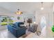 Bright living room with three windows, neutral walls, tile flooring, ceiling fan, and comfortable seating at 100 Diamond Ridge Blvd, Auburndale, FL 33823