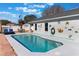 View of the beautiful in-ground pool, showcasing the pool's art wall and surrounding patio at 100 Diamond Ridge Blvd, Auburndale, FL 33823