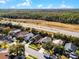 Aerial view of houses in a neighborhood with lush green trees alongside a highway at 1096 Ballyshannon Pkwy, Orlando, FL 32828