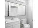 Bathroom with a modern mirror, white vanity, and toilet at 1096 Ballyshannon Pkwy, Orlando, FL 32828