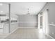 Open dining area with tile flooring, modern chandelier, and view into the kitchen at 1096 Ballyshannon Pkwy, Orlando, FL 32828