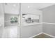 Kitchen view from dining area with serving hatch, white cabinetry, and window views at 1096 Ballyshannon Pkwy, Orlando, FL 32828