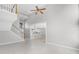 Bright living room showing staircase and view into the kitchen with white cabinets at 1096 Ballyshannon Pkwy, Orlando, FL 32828