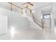 Bright living room with high ceilings, staircase, and tile flooring leading to the front door at 1096 Ballyshannon Pkwy, Orlando, FL 32828