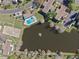 A straight-down view shows a pond with a fountain, community pool, and some landscaping at 112 Windtree Ln # 203, Winter Garden, FL 34787