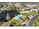 Scenic aerial view of community pool, pond, tennis court and condominium buildings at 112 Windtree Ln # 203, Winter Garden, FL 34787