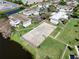 Aerial shot of neighborhood with basketball court and pond at 112 Windtree Ln # 203, Winter Garden, FL 34787