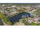 Scenic aerial view of the neighborhood, pond, pool, and commercial area at 112 Windtree Ln # 203, Winter Garden, FL 34787