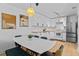 Modern kitchen and dining area featuring white cabinets, stainless steel appliances, and sleek design at 112 Windtree Ln # 203, Winter Garden, FL 34787