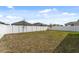 Spacious backyard surrounded by a white vinyl fence at 1171 Lone Palm Way, St Cloud, FL 34771