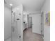 Modern bathroom with a glass-enclosed shower, white tile, and a neutral-toned tile floor at 1171 Lone Palm Way, St Cloud, FL 34771