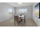 Bright dining area with carpet, a round glass table with four chairs, and large windows at 1171 Lone Palm Way, St Cloud, FL 34771