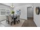 The dining room flows into the entry area of the home with a light-filled window at 1171 Lone Palm Way, St Cloud, FL 34771