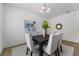 View of the dining room with an abstract painting above the wood table at 1171 Lone Palm Way, St Cloud, FL 34771