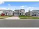 Two-story home featuring a neutral palette, attached garage, and manicured lawn at 1171 Lone Palm Way, St Cloud, FL 34771